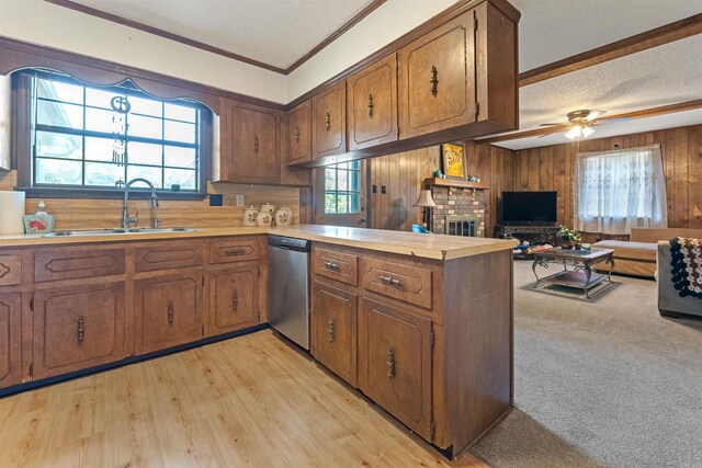 111 Pamela Ln, Sherwood, AR 72120 - kitchen with stainless steel dishwasher, light countertops, a sink, and brown cabinets