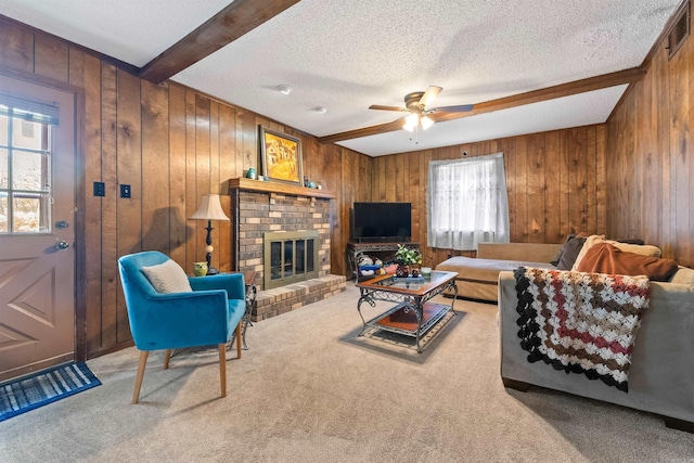 111 Pamela Ln, Sherwood, AR 72120 - living room with a ceiling fan, wood walls, carpet, and a brick fireplace