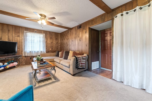 111 Pamela Ln, Sherwood, AR 72120 - carpeted living area featuring wooden walls, visible vents, a textured ceiling, and ceiling fan