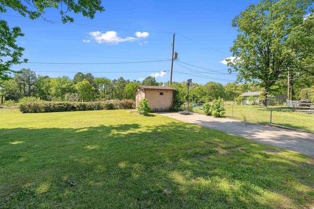 111 Pamela Ln, Sherwood, AR 72120 - view of yard featuring fence, an outbuilding, aphalt driveway, and a storage unit