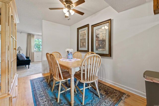 111 Pamela Ln, Sherwood, AR 72120 - dining room featuring light wood-type flooring, a textured ceiling, a ceiling fan, and baseboards