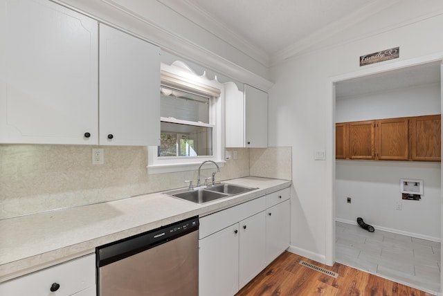kitchen with a sink, visible vents, dishwasher, light countertops, and ornamental molding