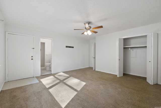 unfurnished bedroom featuring connected bathroom, a ceiling fan, carpet flooring, and a textured ceiling