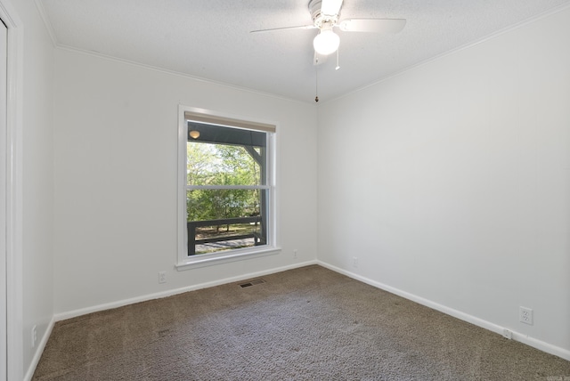 empty room featuring carpet floors, visible vents, and baseboards