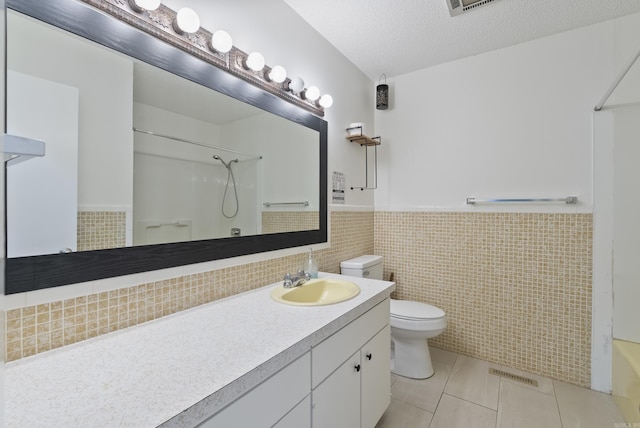 bathroom with toilet, wainscoting, visible vents, tile patterned flooring, and vanity