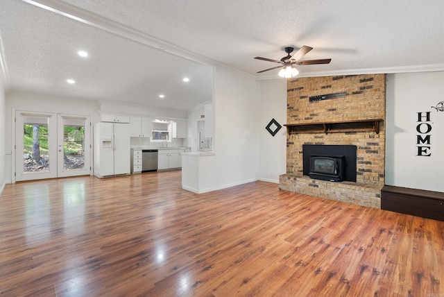 unfurnished living room with ornamental molding, a ceiling fan, a textured ceiling, and a sink