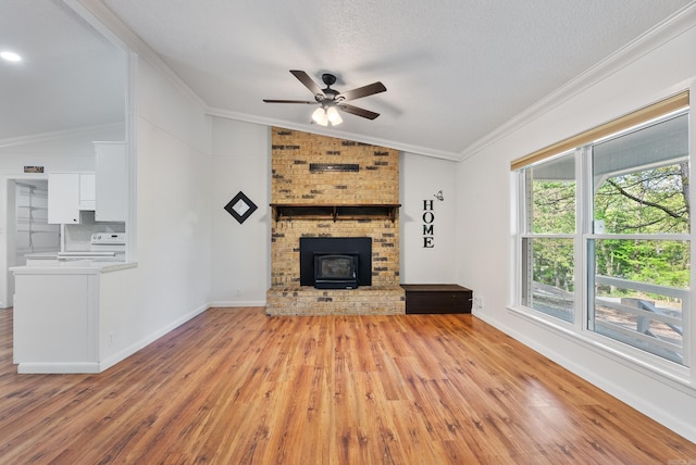unfurnished living room with baseboards, light wood-style floors, lofted ceiling, ceiling fan, and crown molding