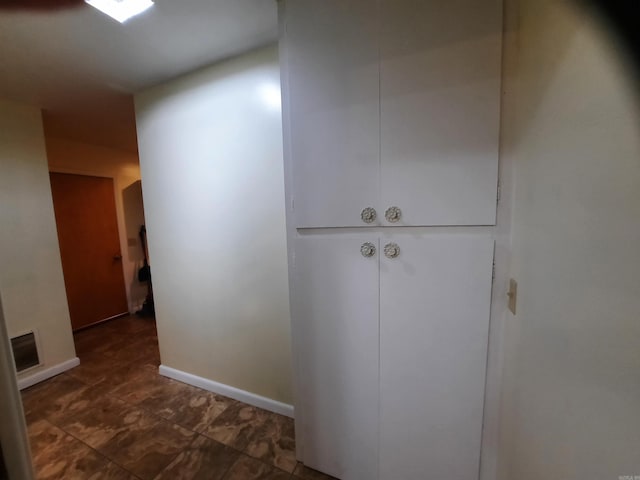 corridor featuring baseboards