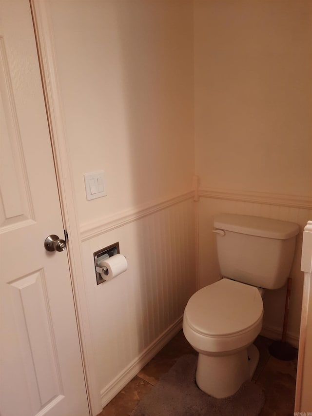 bathroom featuring wainscoting and toilet
