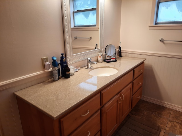 bathroom featuring wainscoting, vanity, and tile patterned flooring