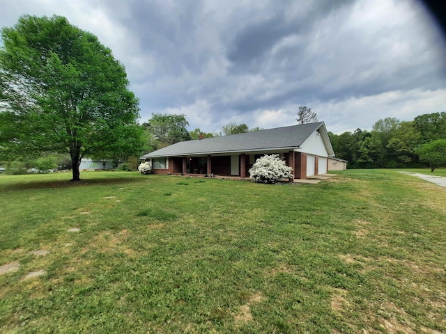 view of home's exterior featuring an attached garage, a porch, and a yard