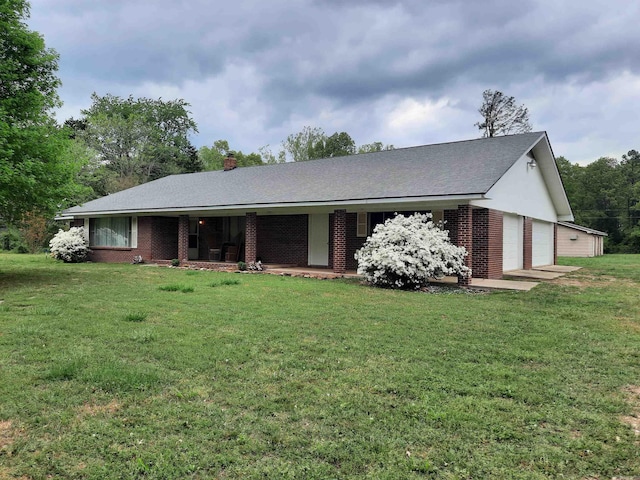 exterior space featuring brick siding, a yard, and covered porch