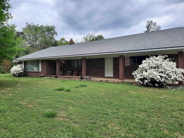 view of front of property with brick siding and a front yard