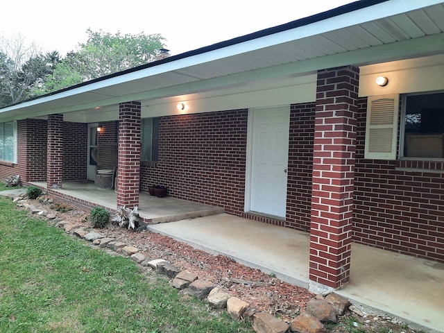 entrance to property featuring brick siding