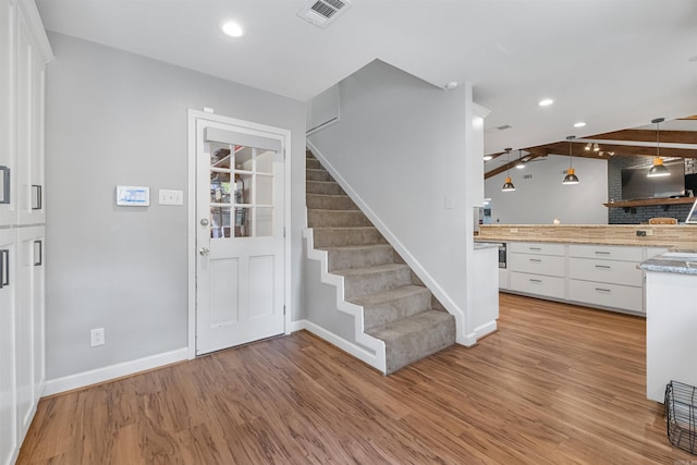 entrance foyer with recessed lighting, light wood finished floors, visible vents, baseboards, and stairs