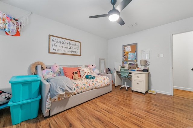 bedroom with ceiling fan, baseboards, visible vents, and light wood-type flooring