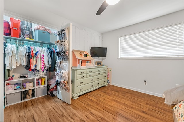 bedroom featuring baseboards, a ceiling fan, and wood finished floors