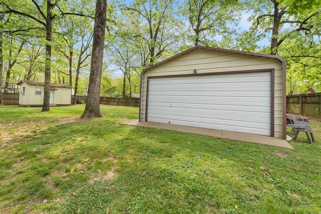 detached garage featuring fence
