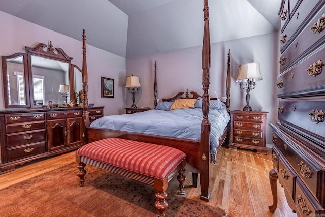 bedroom featuring lofted ceiling and light wood-style floors