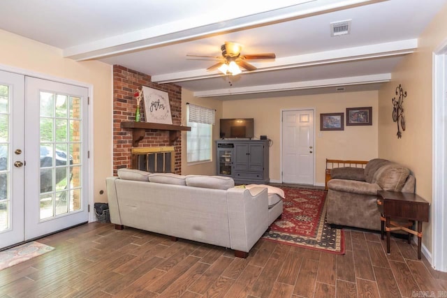 living area with ceiling fan, visible vents, beamed ceiling, baseboards, and dark wood-style floors