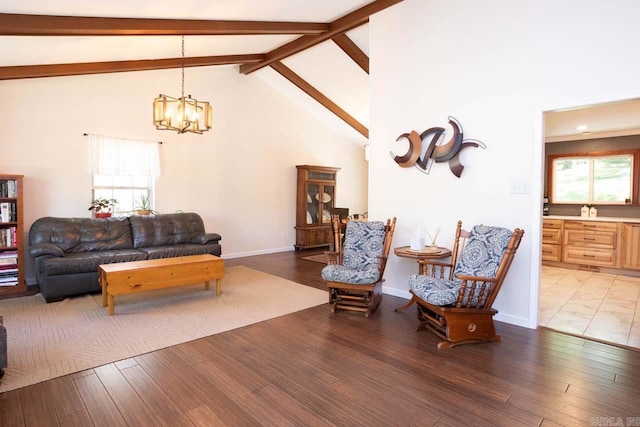 living area with beamed ceiling, baseboards, a chandelier, light wood-style flooring, and high vaulted ceiling