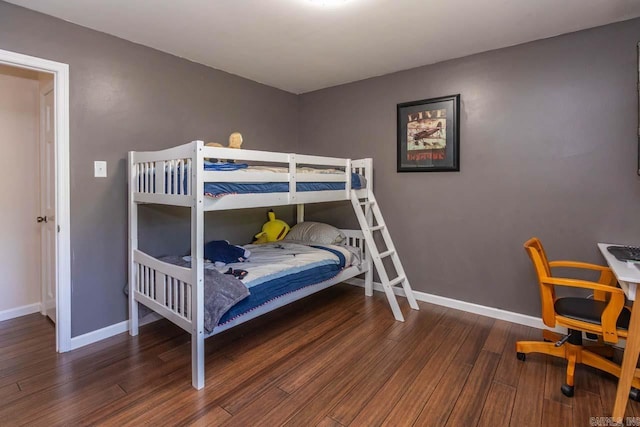 bedroom featuring baseboards and wood finished floors