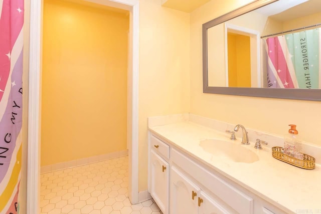 full bathroom with baseboards and vanity