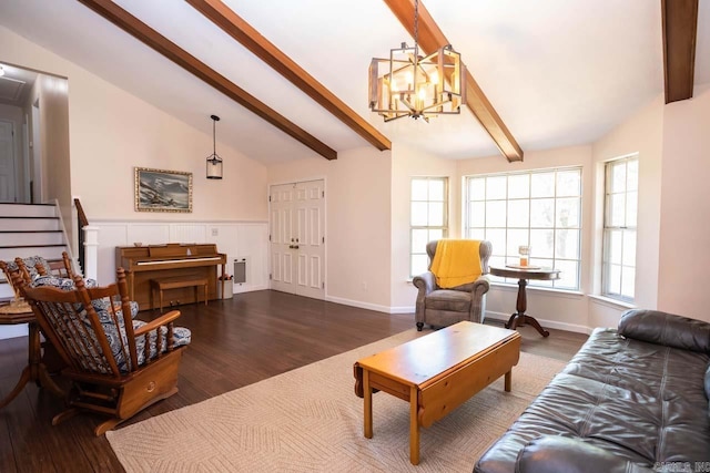 living area featuring lofted ceiling with beams, wood finished floors, and a notable chandelier
