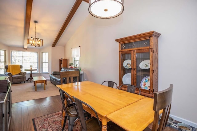 dining area with dark wood-style floors, vaulted ceiling with beams, baseboards, and a notable chandelier