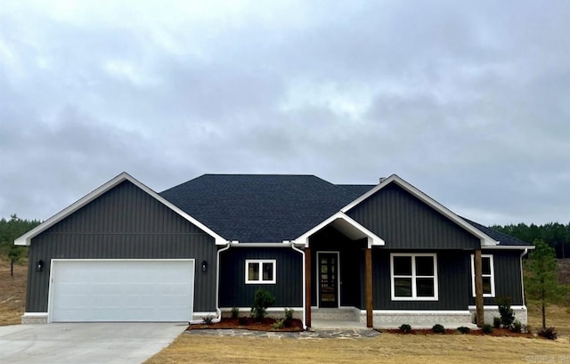 view of front of home with an attached garage, board and batten siding, and concrete driveway
