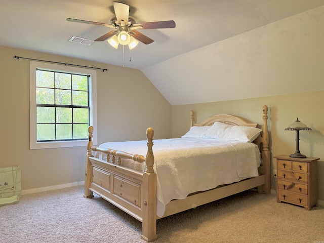 bedroom with vaulted ceiling, visible vents, a ceiling fan, carpet floors, and baseboards
