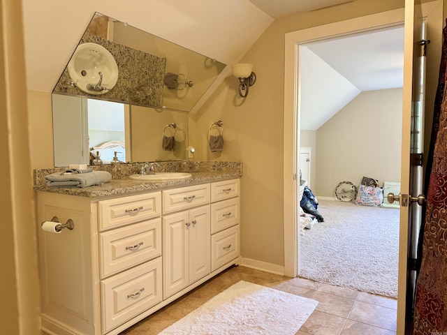 bathroom featuring lofted ceiling, vanity, and tile patterned flooring