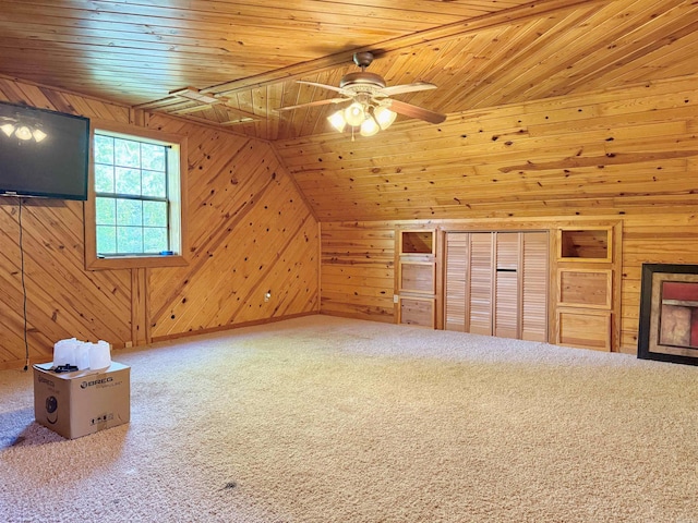 bonus room featuring wooden ceiling, carpet floors, ceiling fan, and wooden walls