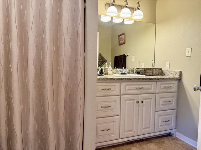 bathroom with baseboards and vanity