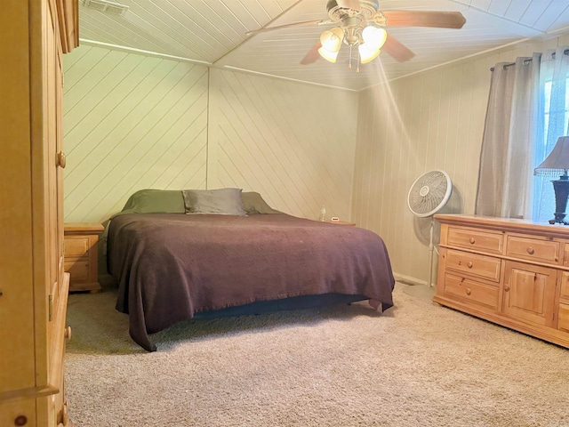 bedroom with wood ceiling, a ceiling fan, wooden walls, and light colored carpet
