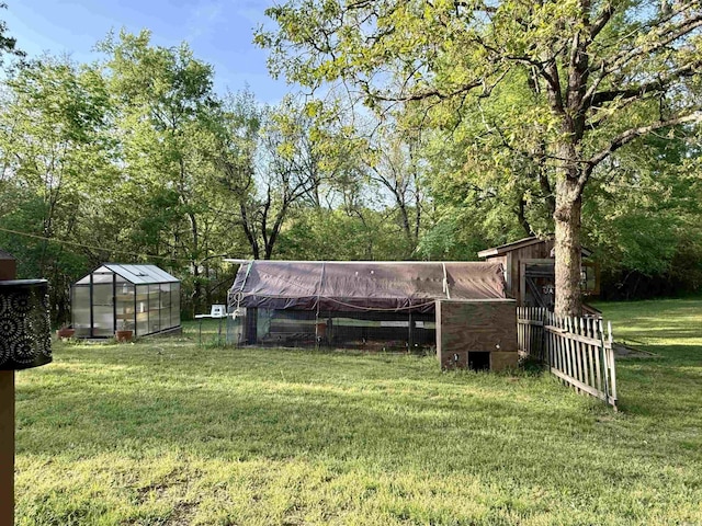 view of yard featuring an outbuilding and an exterior structure