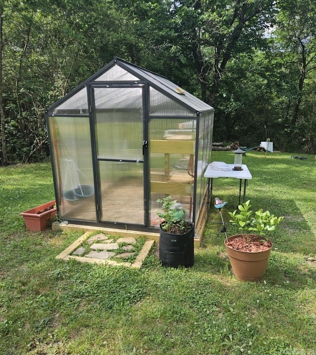 view of greenhouse featuring a yard