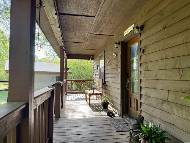 wooden terrace with a porch