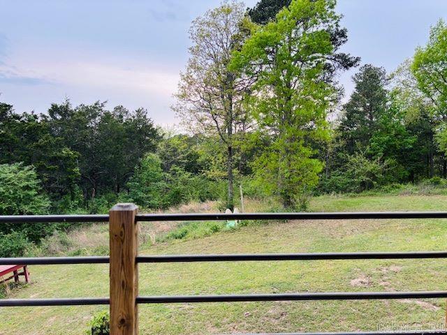 view of gate featuring a lawn and fence