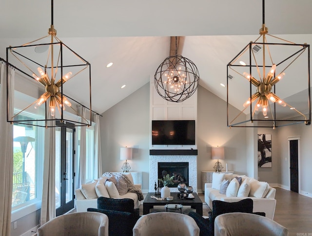 157 Manitou Dr, Maumelle, AR 72113 - living area with wood finished floors, baseboards, a fireplace, high vaulted ceiling, and a notable chandelier