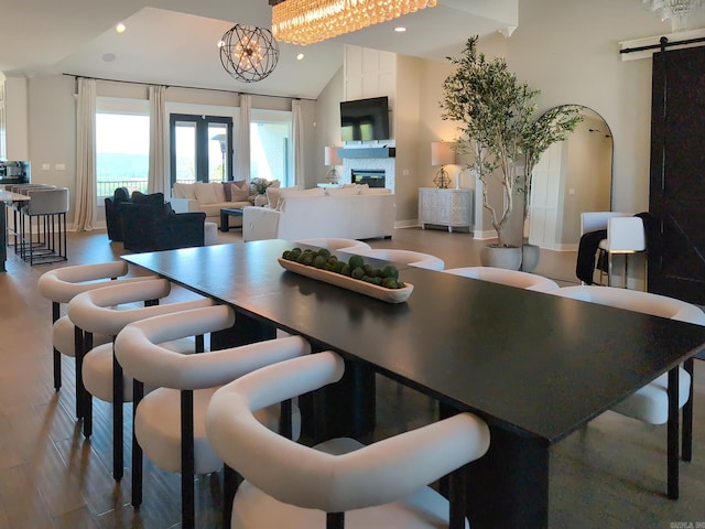 157 Manitou Dr, Maumelle, AR 72113 - dining area featuring a barn door, wood finished floors, a glass covered fireplace, baseboards, and recessed lighting