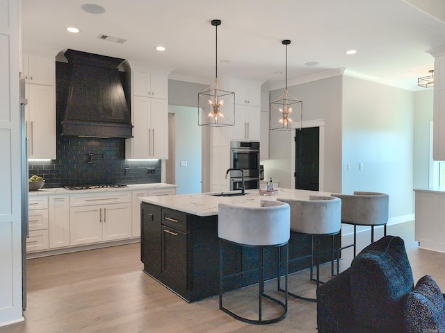 157 Manitou Dr, Maumelle, AR 72113 - kitchen featuring custom exhaust hood, decorative backsplash, stainless steel double oven, white cabinetry, and visible vents