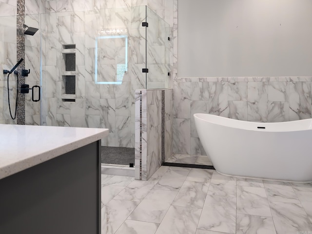 157 Manitou Dr, Maumelle, AR 72113 - bathroom with a freestanding bath, tile walls, marble finish floor, a shower stall, and vanity