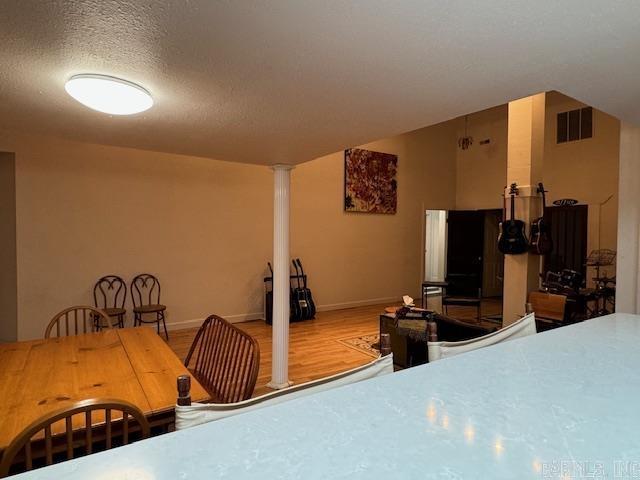 107 N Marr St, Pocahontas, AR 72455 - dining space with baseboards, wood finished floors, visible vents, and a textured ceiling