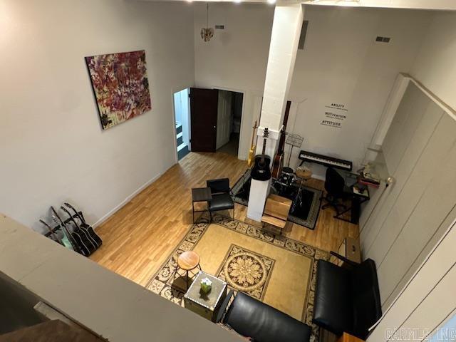 107 N Marr St, Pocahontas, AR 72455 - living area with a towering ceiling, wood finished floors, visible vents, and ornate columns