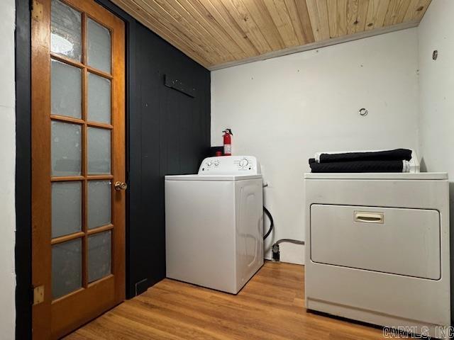 107 N Marr St, Pocahontas, AR 72455 - laundry room with light wood-style flooring, washing machine and clothes dryer, wood ceiling, and laundry area