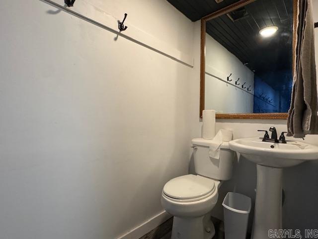 107 N Marr St, Pocahontas, AR 72455 - bathroom featuring wood finished floors, toilet, and baseboards