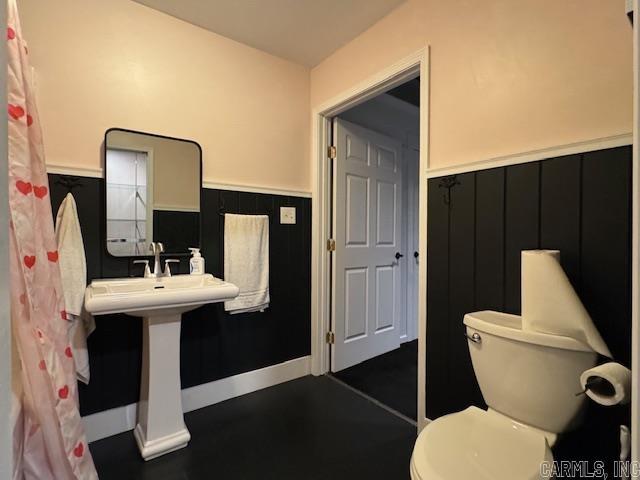 107 N Marr St, Pocahontas, AR 72455 - bathroom with a wainscoted wall and toilet
