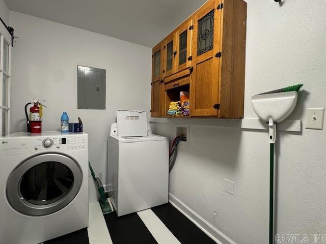 107 N Marr St, Pocahontas, AR 72455 - clothes washing area with washing machine and clothes dryer, electric panel, baseboards, and cabinet space