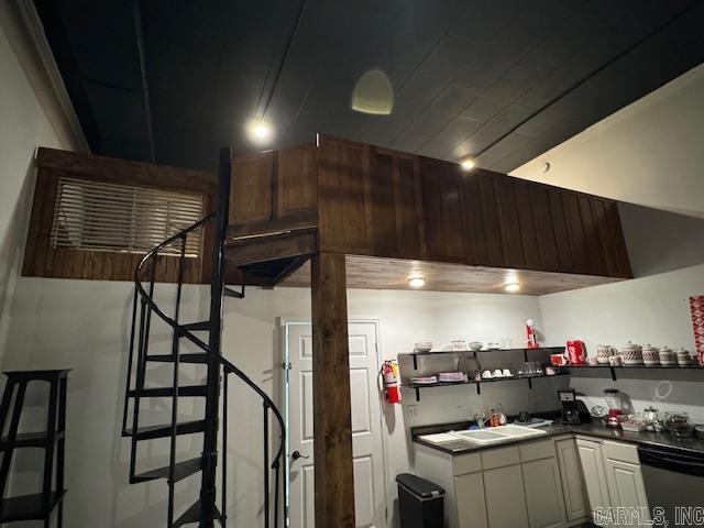 107 N Marr St, Pocahontas, AR 72455 - kitchen featuring stainless steel dishwasher, dark countertops, open shelves, a sink, and white cabinetry